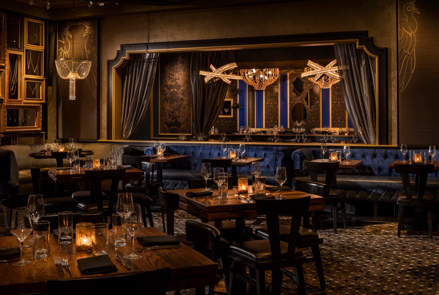The Peacock Room at Beauty & Essex with candlelit tables and blue banquettes