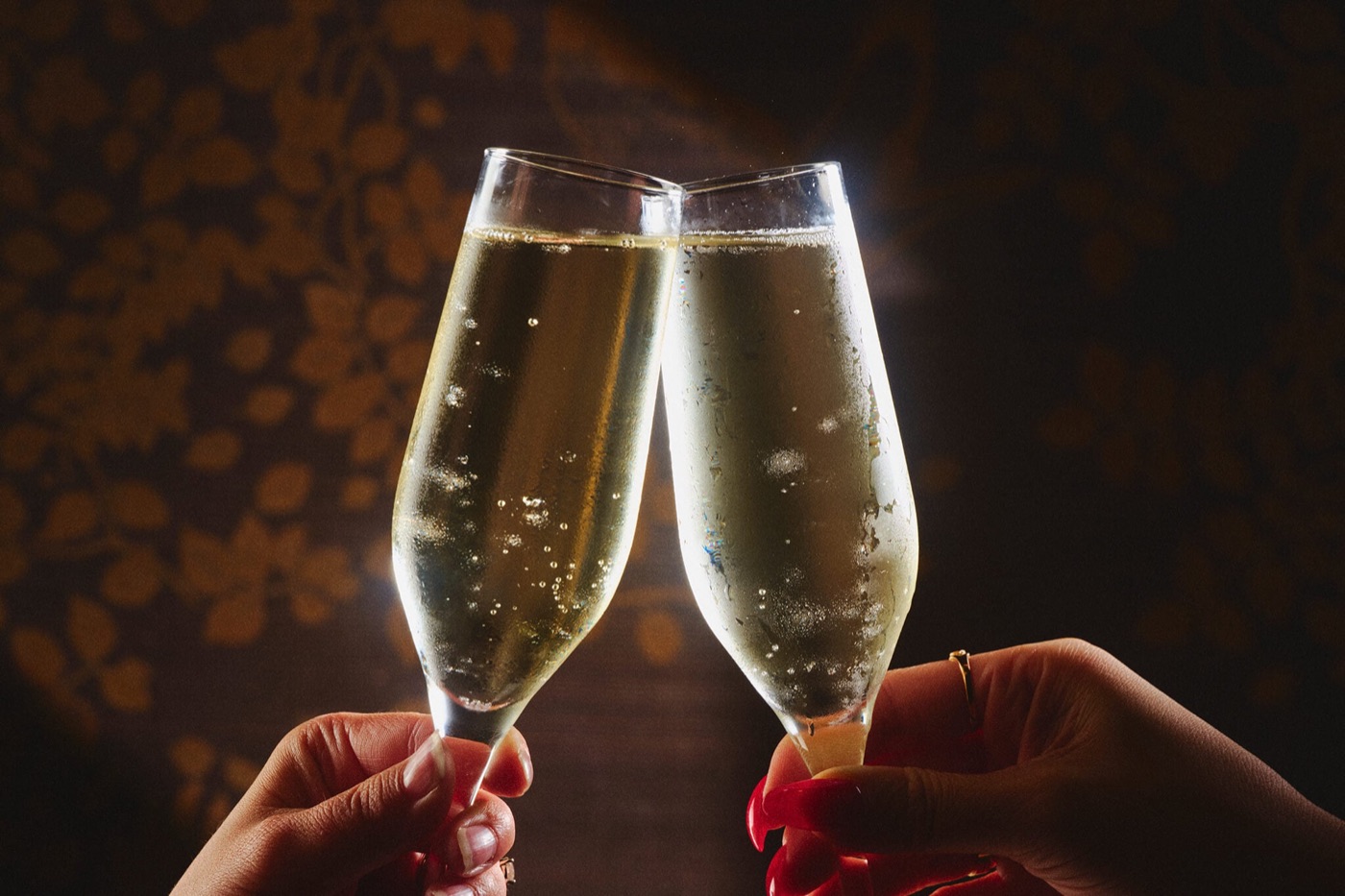 Two champagne glasses raised in a toast
